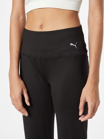 Evazați Pantaloni sport de la PUMA pe negru