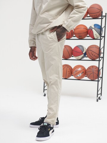 Sinned x ABOUT YOU Regular Trousers 'Hannes' in Beige