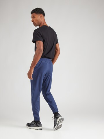 new balance Конический (Tapered) Спортивные штаны 'Essentials Active' в Синий