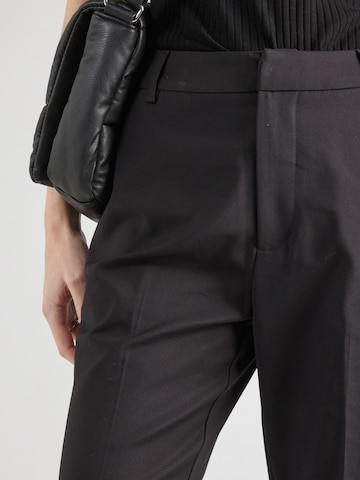 Flared Pantaloni con piega frontale 'Dexa' di minus in nero