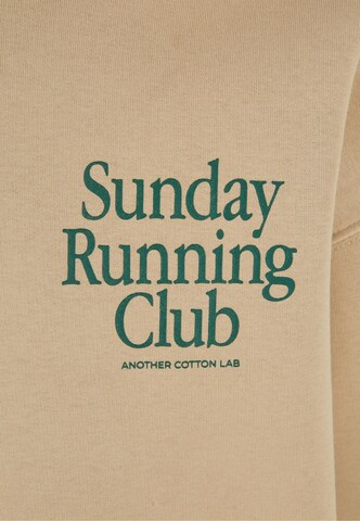 Another Cotton Lab Свитшот 'Sunday Running Club' в Бежевый