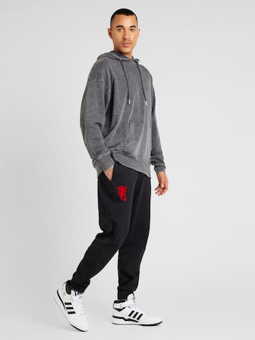 ADIDAS PERFORMANCE Tapered Workout Pants 'Manchester United Cultural Story' in Black