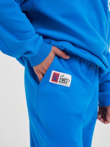 Effilé Pantalon fonctionnel AND1 en bleu