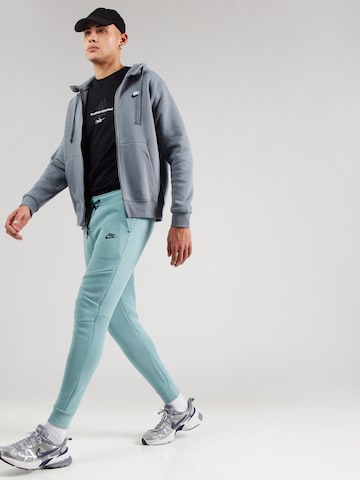 Effilé Pantalon 'TCH FLC' Nike Sportswear en vert