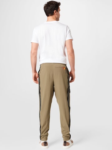 UNDER ARMOUR Tapered Sportsbukser 'Rush' i grøn
