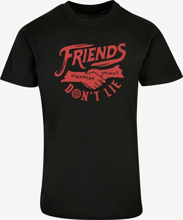 ABSOLUTE CULT T-Shirt 'Stranger Things - Friends Dont Lie' in Schwarz: predná strana