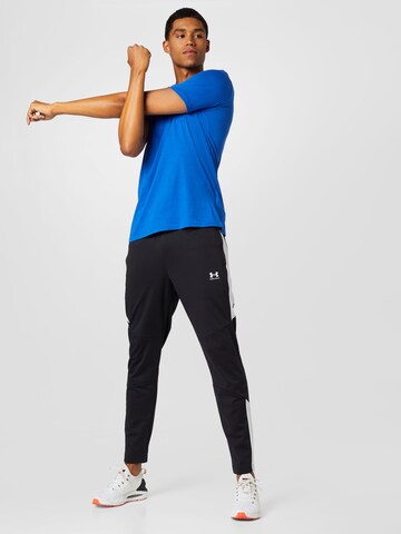 Effilé Pantalon de sport UNDER ARMOUR en noir