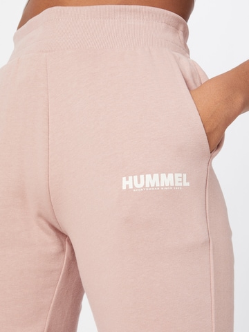 Hummel Zwężany krój Spodnie sportowe w kolorze różowy