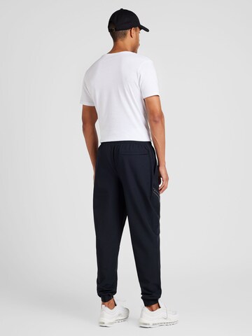 UNDER ARMOUR Tapered Sports trousers 'Unstoppable' in Black