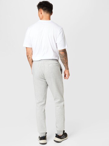 Tapered Pantaloni sportivi 'Essentials' di ADIDAS SPORTSWEAR in grigio