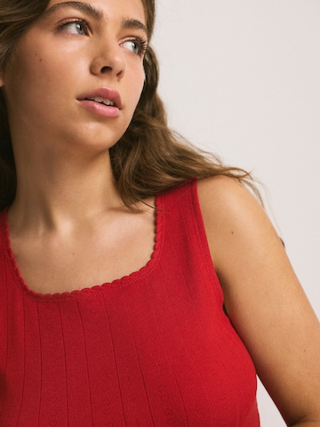 Haut Next en rouge