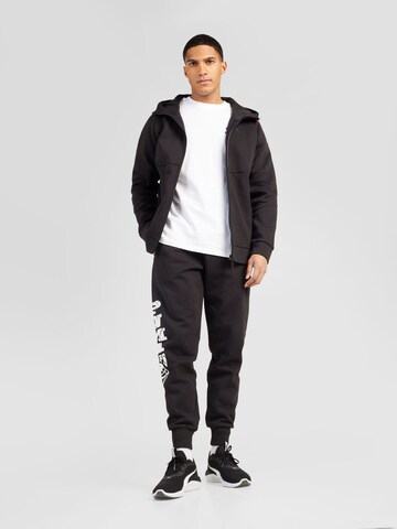 PUMA Tapered Sports trousers 'Posterize 2.0' in Black