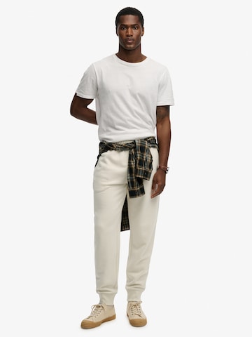 bēšs Superdry & Co Pakapēniski sašaurināts piegriezums Bikses 'ESSENTIAL'