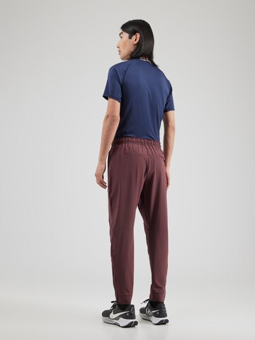 NIKE Tapered Sports trousers 'UNLIMITED' in Red