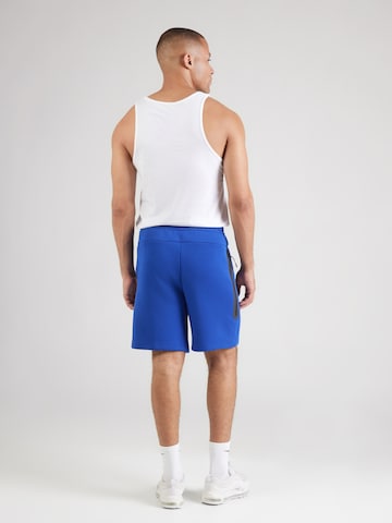 Nike SportswearLoosefit Hlače 'TECH FLC' - plava boja