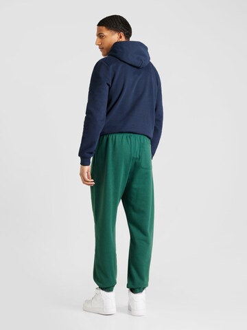 new balance Zwężany krój Spodnie w kolorze zielony