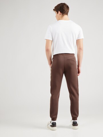 Tapered Pantaloni 'MICKEY' di GUESS in marrone
