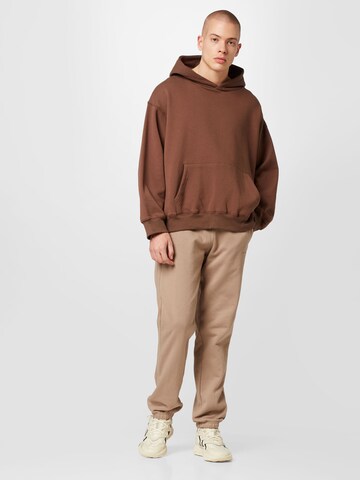 ADIDAS ORIGINALSTapered Hlače 'Reveal Essentials' - smeđa boja
