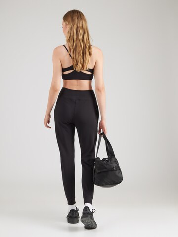 UNDER ARMOUR - Tapered Pantalón deportivo 'Motion' en negro