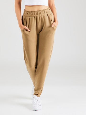 Athlecia Tapered Sports trousers in Brown: front