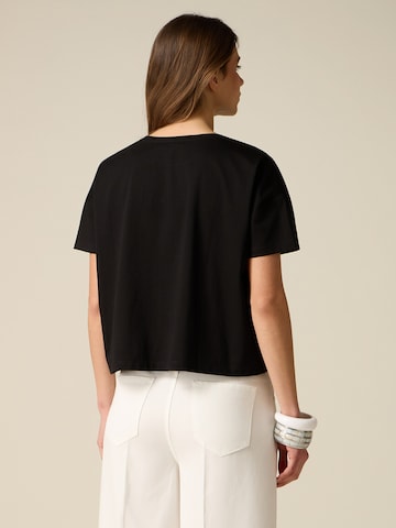 Top di oltre in nero