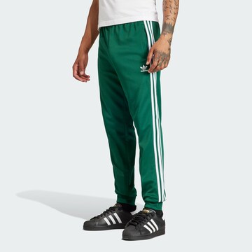 ADIDAS ORIGINALS Tapered Pants 'Adicolor Classics Sst' in Green: front