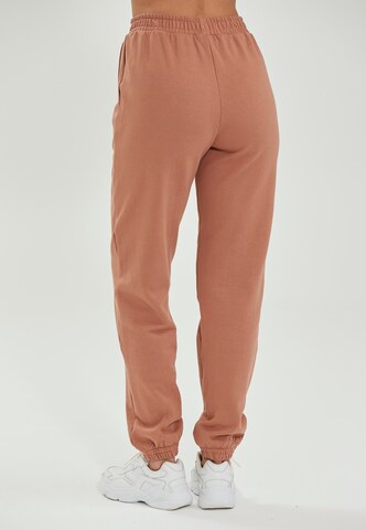 Athlecia Tapered Sportbroek 'Lia' in Bruin