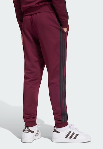 Tapered Pantaloni 'SST' di ADIDAS ORIGINALS in rosso