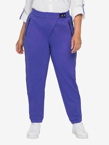 SHEEGO Tapered Pleat-Front Pants in Purple: front