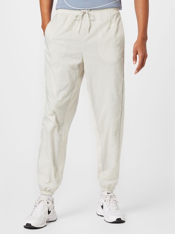 Nike Sportswear Tapered Pants in Beige: front