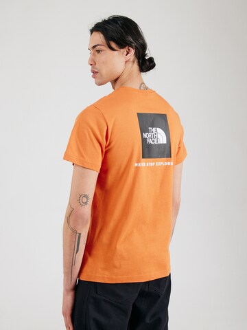 THE NORTH FACE Koszulka 'REDBOX' w kolorze pomarańczowy: przód