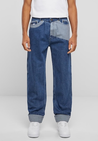 Karl Kani Tapered Pleated Jeans in Blue: front