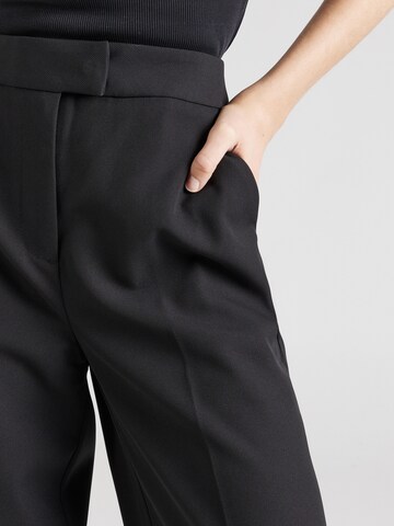 ABOUT YOU x Iconic by Tatiana Kucharova Wide leg Trousers with creases 'Vicky' in Black