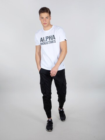 Effilé Pantalon cargo ALPHA INDUSTRIES en noir