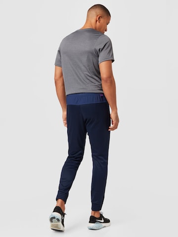 NIKE Tapered Sports trousers in Blue