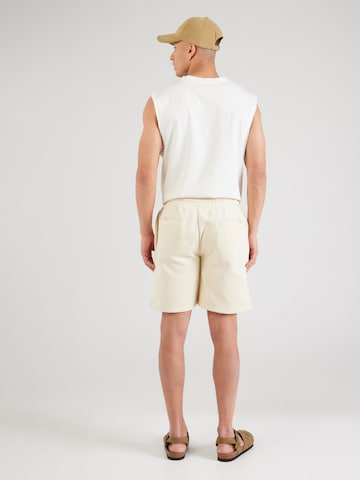 Karl Kani Regular Pants in Beige