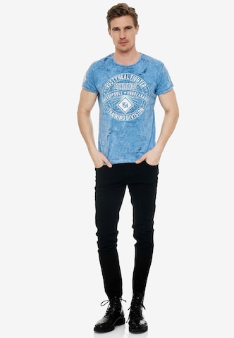 Rusty Neal Cooles T-Shirt mit großem Front- Print in Blau