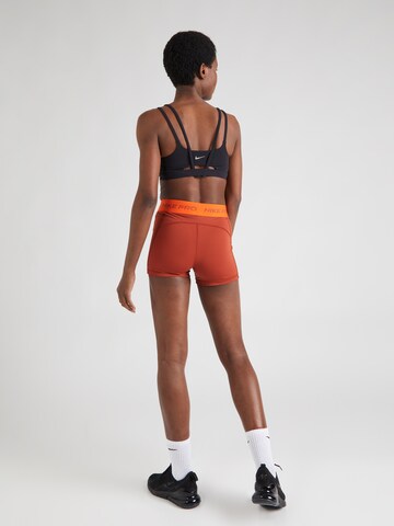 NIKE Skinny Sports trousers in Orange