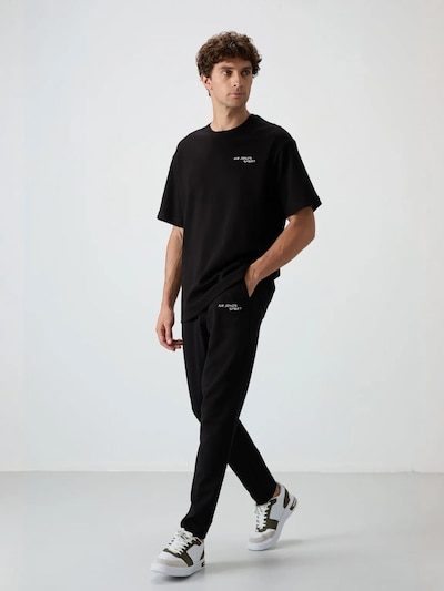 Completo sportivo in L Tommy Life di colore nero, Visualizzazione prodotti