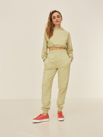 ABOUT YOU x Sofia Tsakiridou Regular Trousers 'Nora' in Green