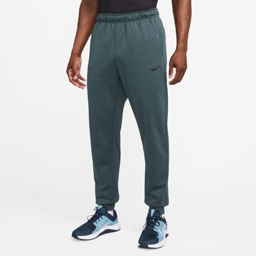NIKE Tapered Athletic Pants in Green: front