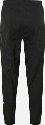 Reebok - Tapered Pantalón deportivo en negro