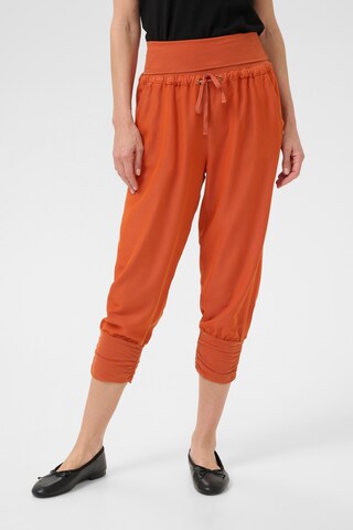 Cream Tapered Harem trousers 'Linee' in Orange: front