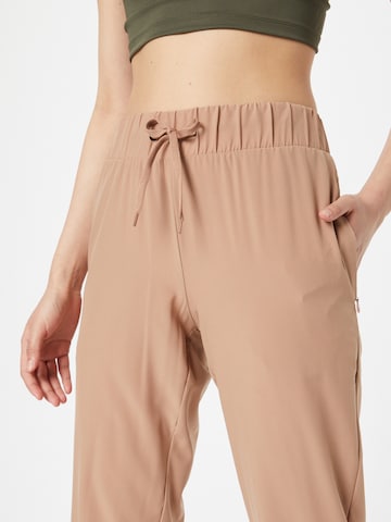 Athlecia Tapered Sports trousers 'Austberg' in Brown
