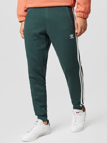 Tapered Pantaloni 'Adicolor' de la ADIDAS ORIGINALS pe verde: față
