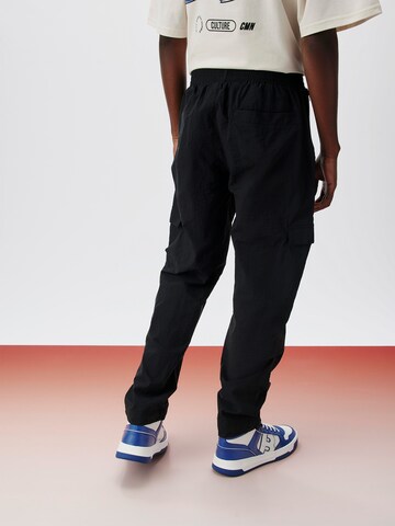 ABOUT YOU x Kingsley Coman Tapered Cargo Pants 'Enzo' in Black