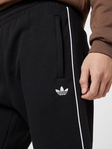 ADIDAS ORIGINALS Tapered Housut 'Adicolor Seasonal Archive' värissä musta