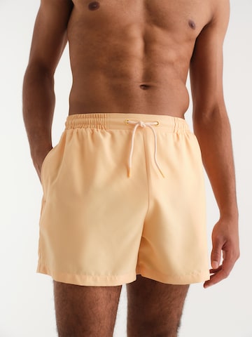 ABOUT YOU x Kevin Trapp Board Shorts 'Ibrahim' in Orange: front