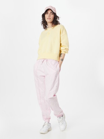 ADIDAS SPORTSWEAR Tapered Sports trousers 'Loose With Healing Crystals-Inspired Graphics' in Pink