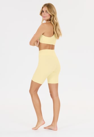 Athlecia Slim fit Sports trousers 'Blossom' in Yellow